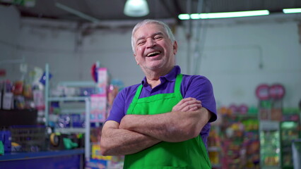 Joyful Supermarket Manager with Arms Crossed, smiling Expression of Older Small Business Owner Inside Store