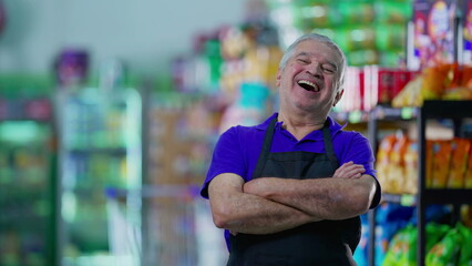 Happy older worker staff laughing and smiling inside supermarket grocery store, senior employee of local business, job occupation concept