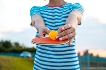 Woman holding ping pong paddle  table tennis paddle with ball. Close up. Concept of healthy life.