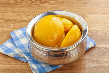 Sweet canned peaches with syrope