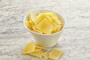 Sliced parmesan cheese heap in the bowl