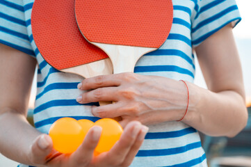 Woman holding ping pong paddle  table tennis paddle with ball. Close up. Concept of sport and...