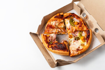 Two different leftover pizza in open cardboard box isolated on white background. top view