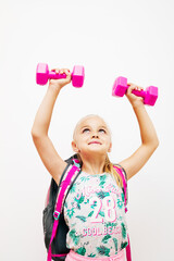 Little girl with backpack and dumbbells