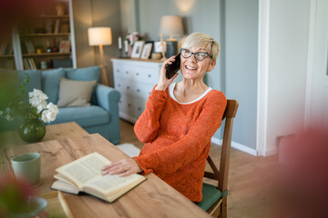 one mature senior caucasian woman use mobile phone smartphone at home