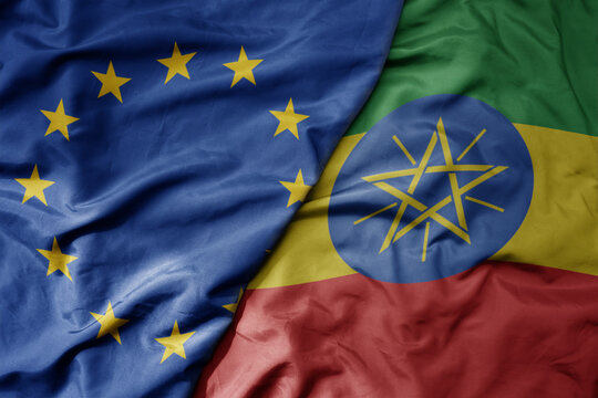 big waving realistic national colorful flag of european union and national flag of ethiopia .
