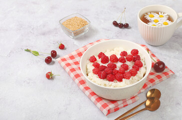 Healthy breakfast with ingredients, milk rice porridge with fresh raspberries, creamy rice pudding or french rice with flax seeds. Natural nutrition and weight loss concept,