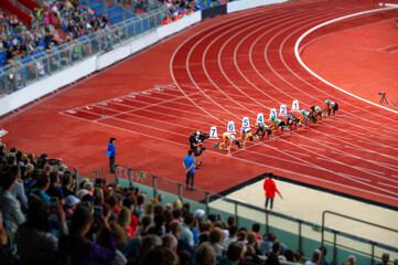 Female Sprinters at the start line of the 100 meters sprint race. Track and Field photo for Summer Game in Paris