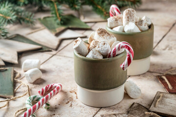 Holiday xmas food mug with hot chocolate cocoa and marshmallows decorated with candy canes with fir...