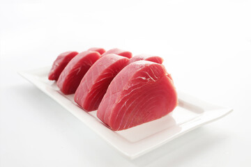 Steaks of fresh tuna fillet on white background. Copy space. Isolated object.
