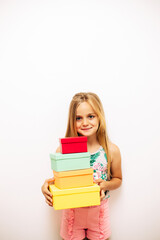 Portrait of an adorable little girl with colorful boxes