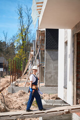 Woman general contractor coming to house under construction for maintenance