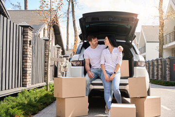 Husband and wife sit surrounded by boxes