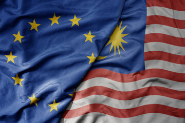 big waving realistic national colorful flag of european union and national flag of malaysia .