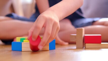 smart child, schoolboy playing with educational toy, wooden geometric figures, blocks in boy's hands, developing brain games, concept childhood, earlier child development, creativity, early training - Powered by Adobe
