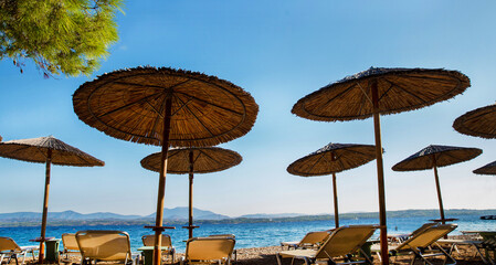 Idyllic view on Straw awning  on the beach on Greek  Island - fantastic vacations on ecological...