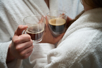 Close-up of woman hand passing cup of coffee to man