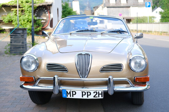 beige vintage VW Cabriolet, Retro german sport car Volkswagen karmann ghia cabrio Typ 14 parked on street, Oldtimer car, headlights, retro-style, Bacharach, Germany - June 17, 2023