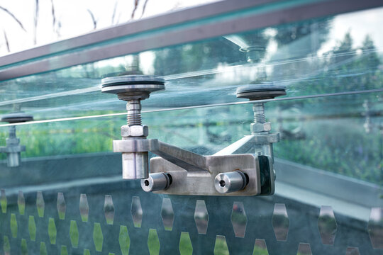 glass pergola steel roof mounts bolted fixed to transparent wall, modern architecture framless close-up, nobody.