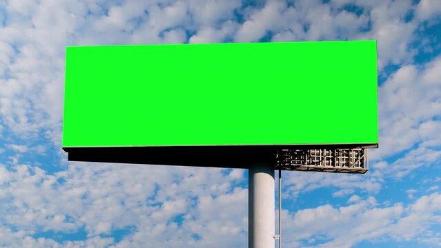 Timelapse: blank green billboard or large display and moving white clouds against blue sky. Consumerism, time lapse, advertising, green screen, template, mock up, copy space and chroma key concept