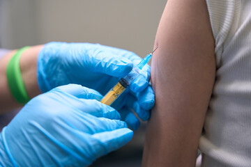 Patient in the injection room receives prophylactic inoculation in arm