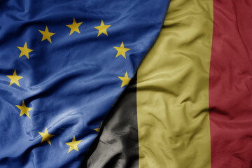 big waving realistic national colorful flag of european union and national flag of belgium .