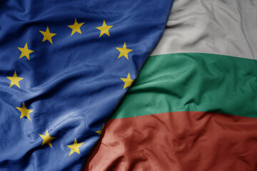 big waving realistic national colorful flag of european union and national flag of bulgaria .