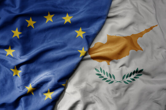 big waving realistic national colorful flag of european union and national flag of cyprus .
