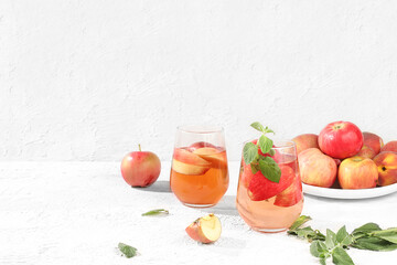 Autumn vitamin mulled wine with apple slices and mint.Apple cider, juice or fruit drink in a glass...
