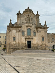 Fototapeta na wymiar Chiesa di San Francesco d'Assisi (or Saint Francis of Assisi Catholic Church) of Matera, Italy is shown during the day in a vertical view.
