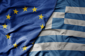 big waving realistic national colorful flag of european union and national flag of greece .