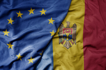 big waving realistic national colorful flag of european union and national flag of moldova .