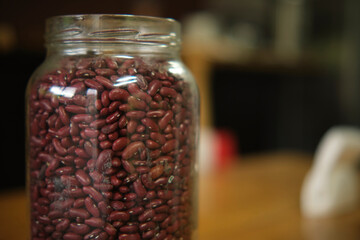 Beans in a glass jar, on a wooden table