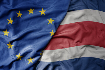 big waving realistic national colorful flag of european union and national flag of costa rica .