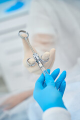 Doctor takes a syringe with painkillers from the assistants hands