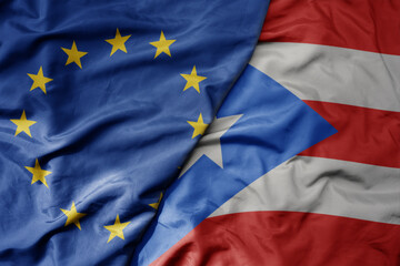 big waving realistic national colorful flag of european union and national flag of puerto rico .