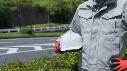 道路に立つ作業服の男性｜建設業イメージ