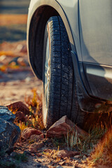 Car wheel standing offroad on stone close-up view © chaossart