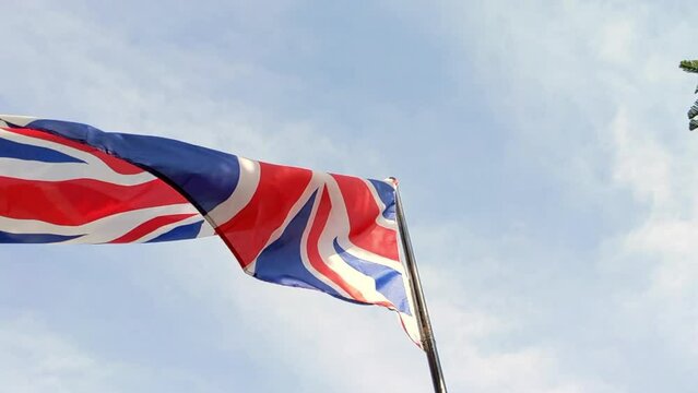 Cinematic shot. United Kingdom flag waving in the wind