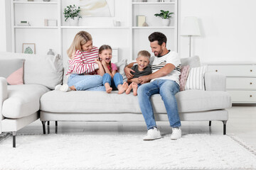 Happy family having fun together on sofa at home