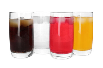 Glasses of different refreshing soda water with ice cubes on white background