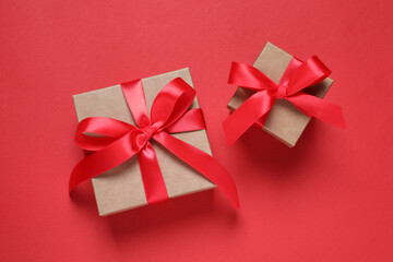 Beautiful gift boxes on red background, flat lay