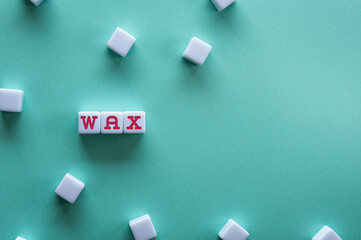There is white cube with the word WAX. It is an abbreviation for WAX as eye-catching image.