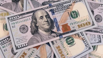 100 dollars bills close-up, slowly rotating background in a pile of hundreds of american US dollars. Concept of finance and money payment. - Powered by Adobe
