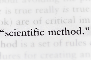 term scientific method printed in textbook focused in closeup of explanation