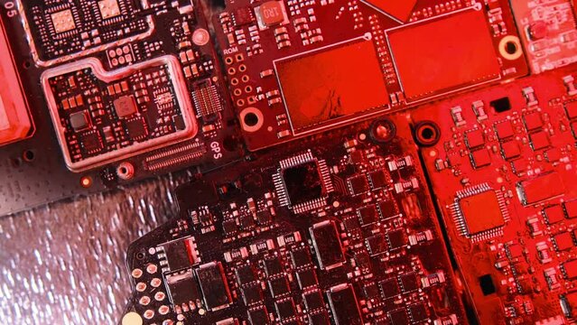 Microchips top view alarming flashing neon light, CPU processor. Computer motherboard components. PC chip close up, slowly tracking shot.