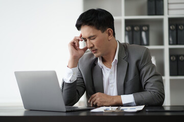 Headache, tired and businessman working in the office with eye strain from the compute.