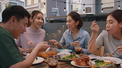 Mom enjoy thai meal cooking for family day meet talk home dining at dine table cozy patio. Group asia people young adult man woman friend fun joy relax warm night time picnic eat yummy food with mum.