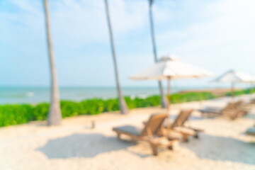 abstract blur umbrella with beach chair for background