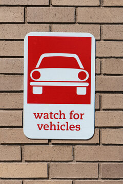 Warning sign or pedestriansto watch for cars.